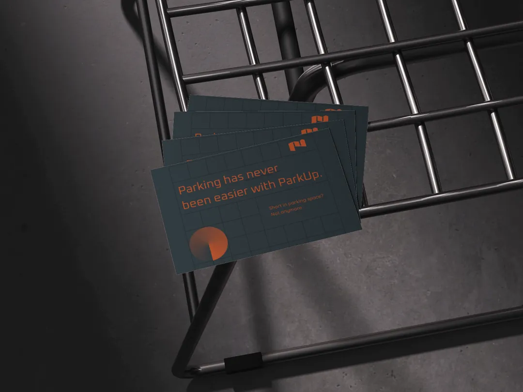 Business cards that are a part of parkup dubai - laying on a metal chair